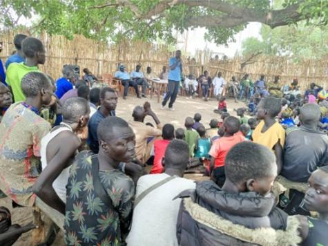 IDAT church plant in Tonj East: crowded people listening to the speaker in the middle.