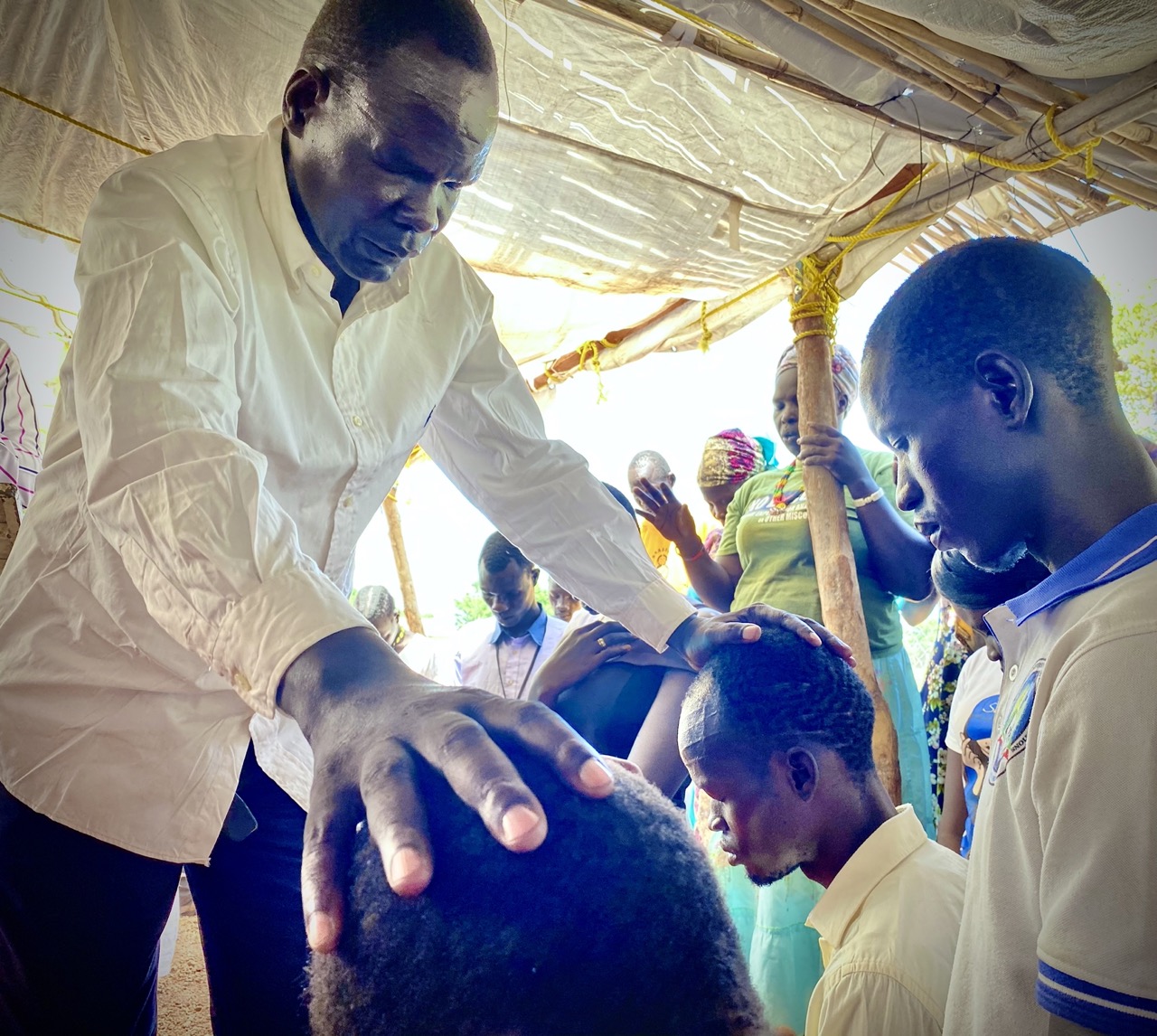 A man praying for the villagers.