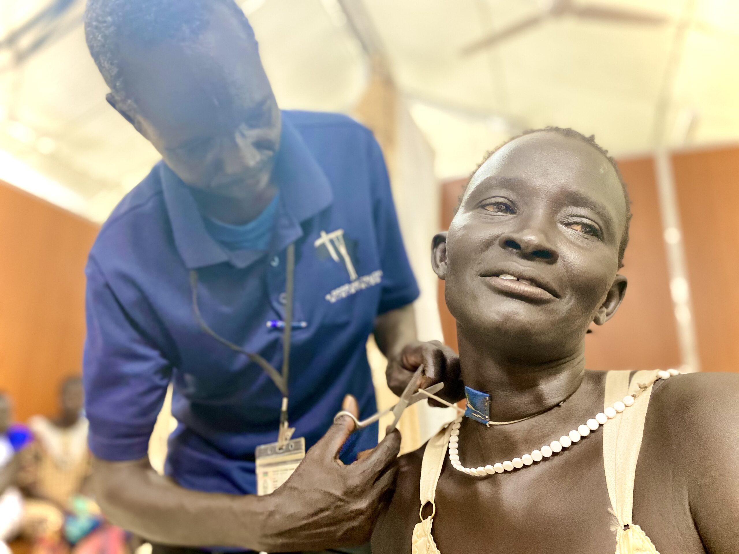 A woman getting medical treatment by a medical professional