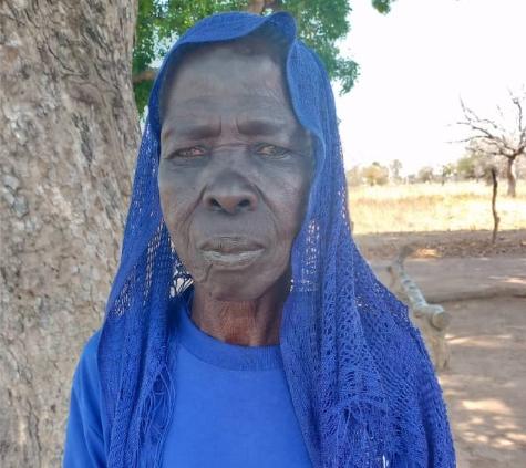 Old woman in indigo shirt and head covering