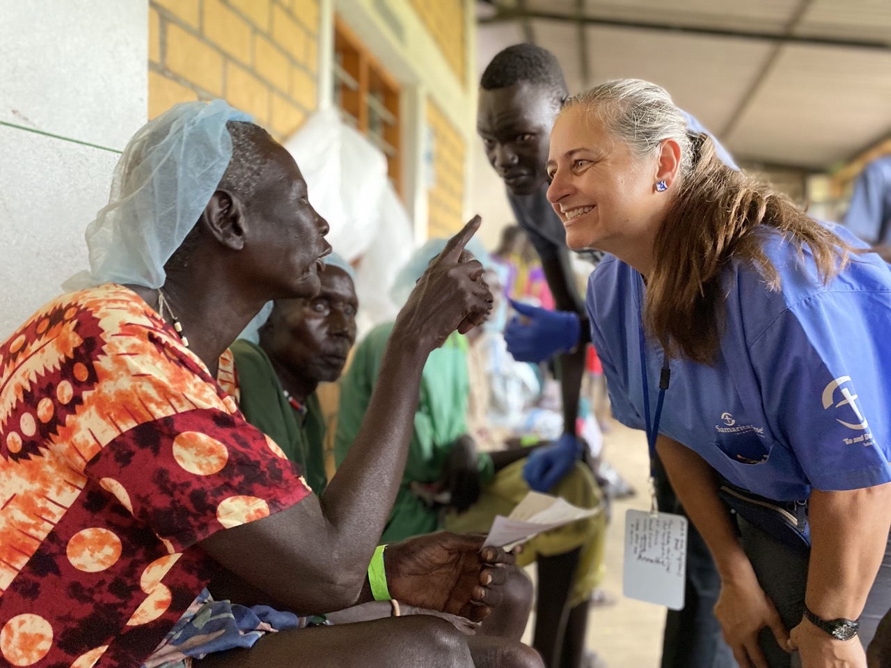 A medical worker talking to a lady