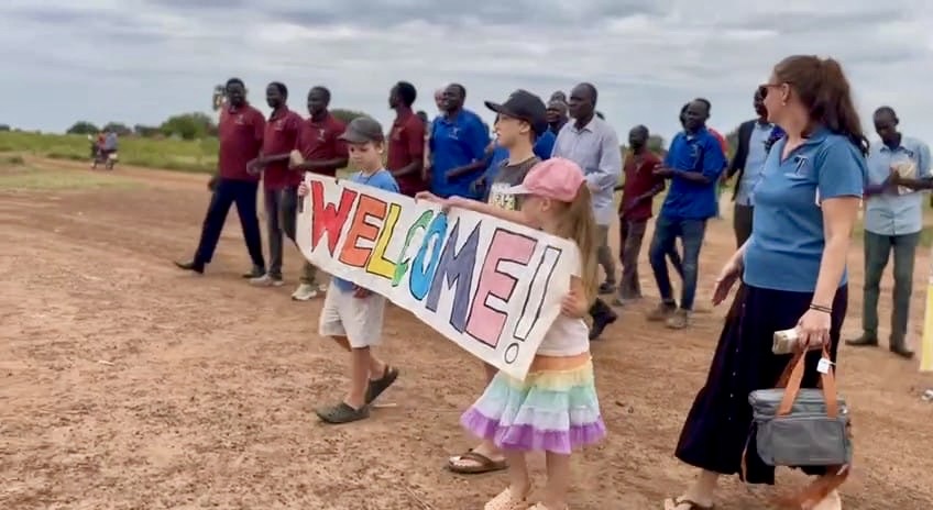 A group of people holding a sign