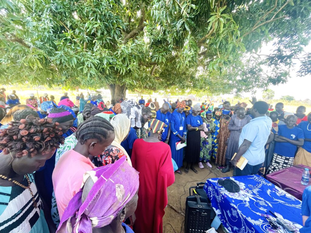 A group of people standing under a tree
