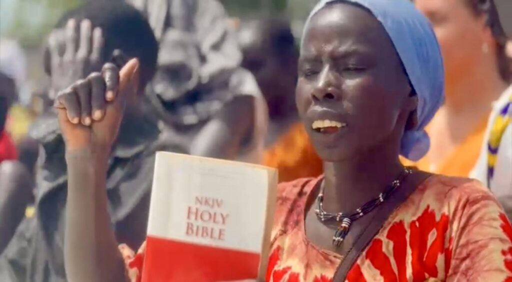 A person holding a book in prayer