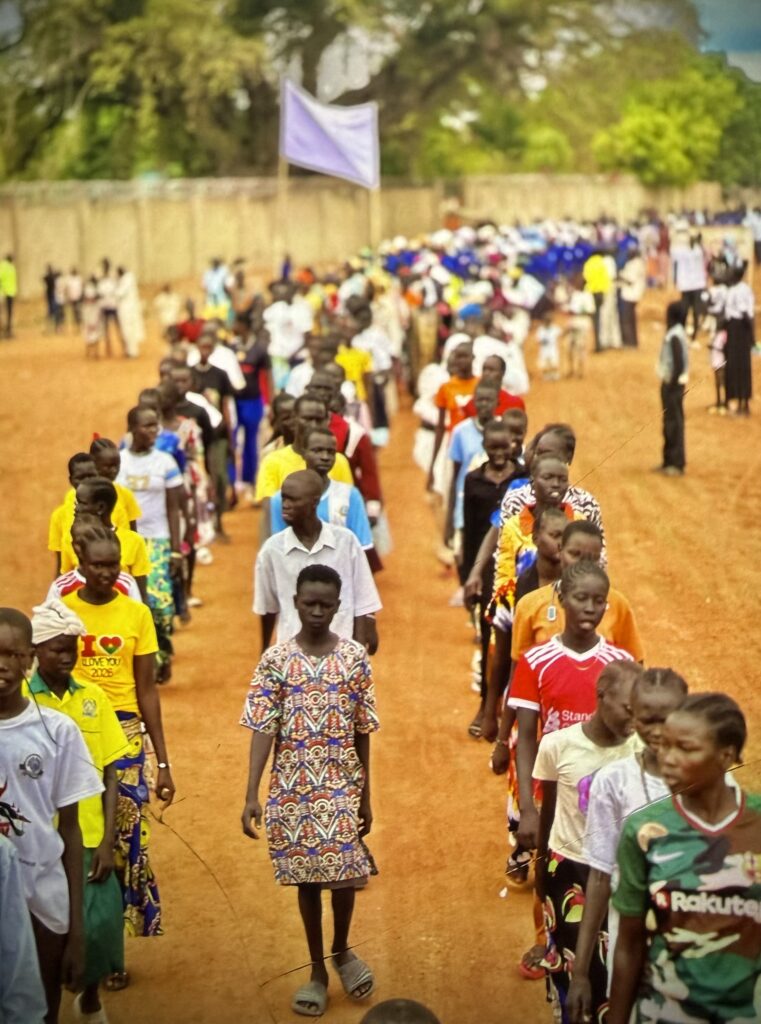 People walking on a dirt road, 